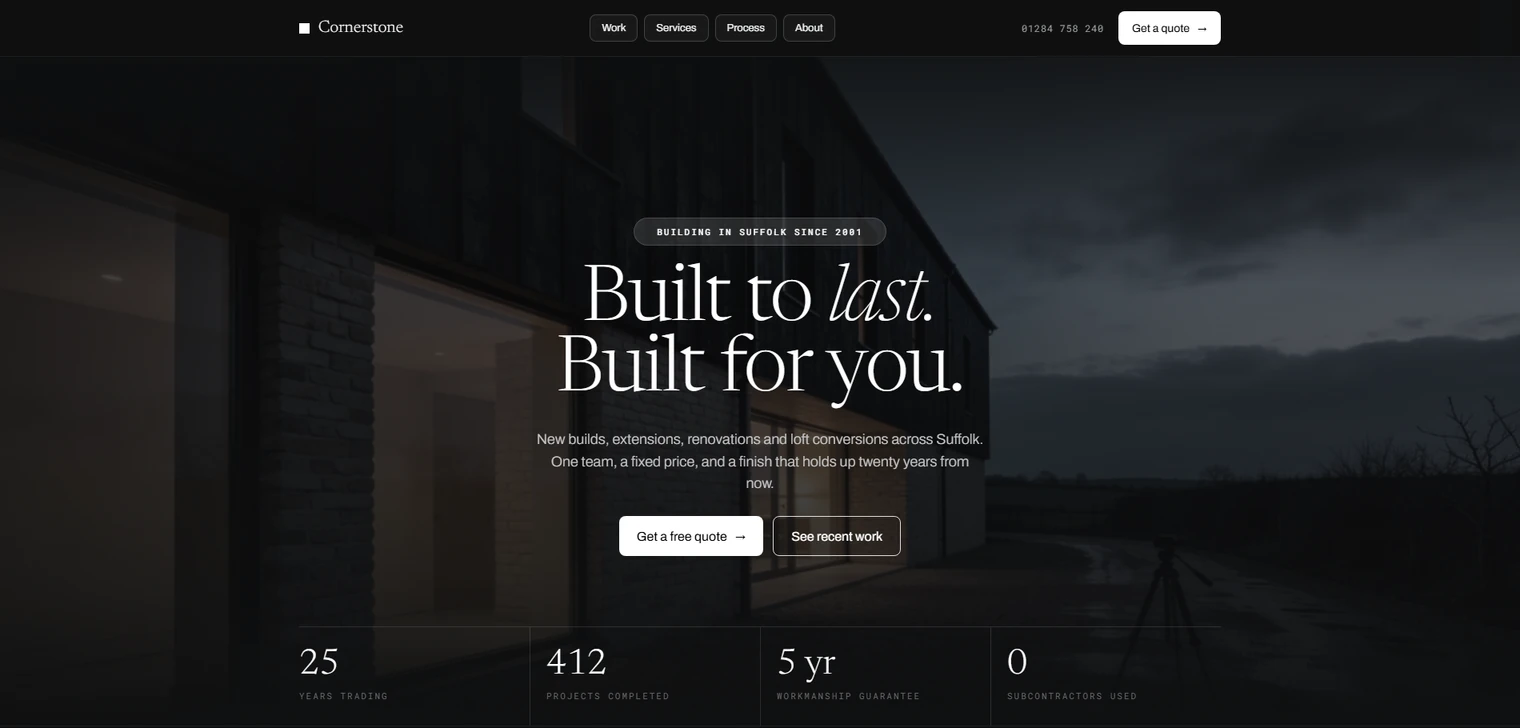 The Cornerstone Construction homepage, a dusk photograph of a timber-clad Suffolk barn behind a Built to last, Built for you headline